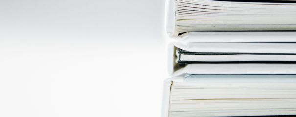 A stack of three white folders against a white background.