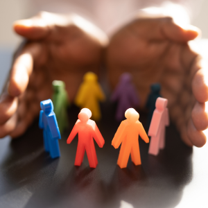 hands opening up around colourful figurines